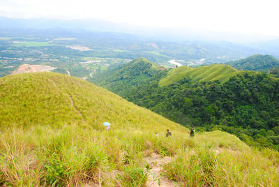 Scenic view of field and mountains against sky