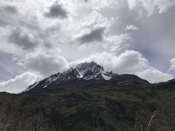 Scenic view of mountains against cloudy sky