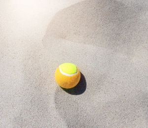 High angle view of yellow ball on sand