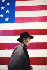 Low angle view of man climbing flag