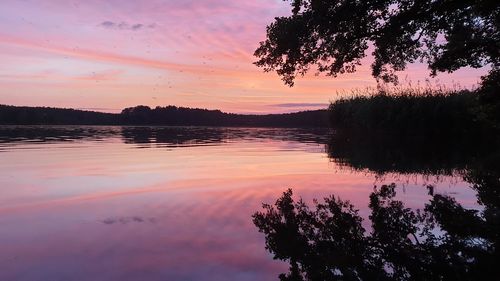 Scenic view of lake against sky at sunset
