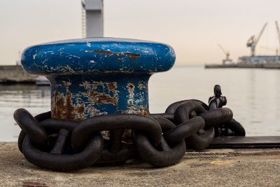 Close-up of rusty chain on pier