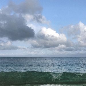 Scenic view of sea against cloudy sky