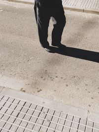 Low section of woman standing on tiled floor