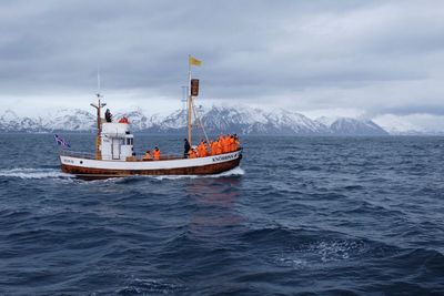 Ship sailing on sea against sky