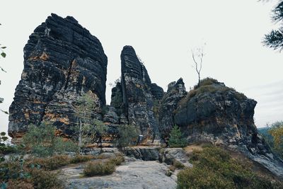 Rock formations on landscape against sky