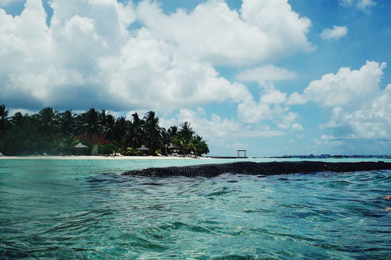 water, sea, sky, tranquil scene, tranquility, scenics, blue, waterfront, beauty in nature, cloud - sky, horizon over water, nature, cloud, beach, tree, rippled, idyllic, cloudy, day, shore