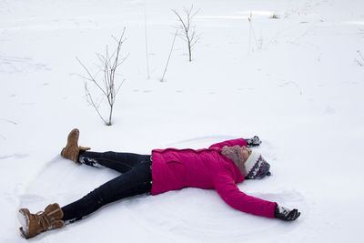 Woman lying down on snow