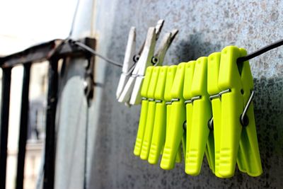 Close-up of clothespins hanging on clothesline