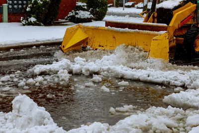 Snow covered yellow by sea during winter