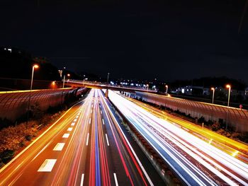 High angle view of light trails on highway at night