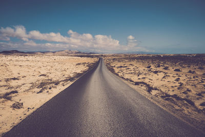 Surface level of empty road against sky