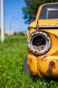 Old yellow wrecked car in vintage style. abandoned rusty yellow car. 