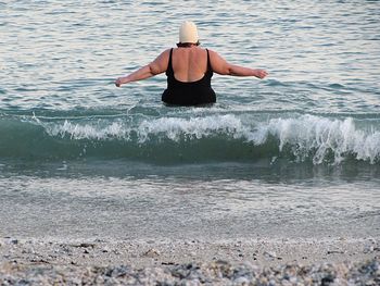 Rear view of woman in sea