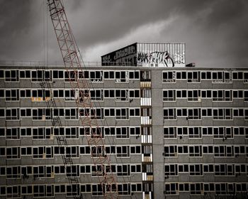 Low angle view of built structure against cloudy sky