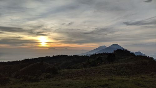 Scenic view of mountains against sky during sunset