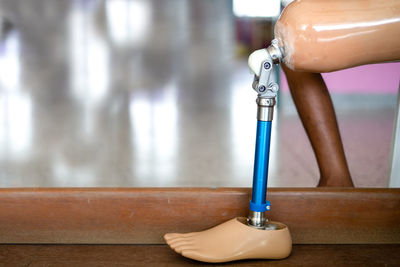 Close-up of faucet on table against wall