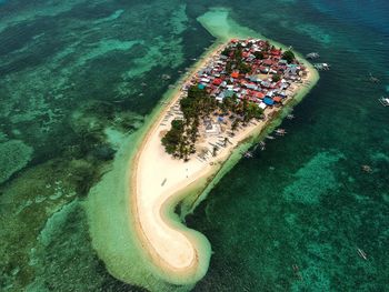 Aerial view of houses on island amidst sea