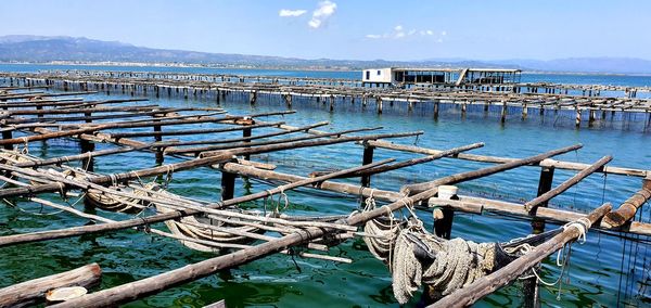 Pier over sea against blue sky