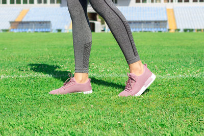 Low section of woman on field