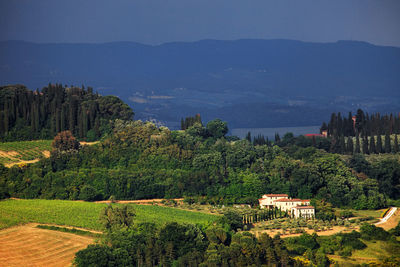 Scenic view of trees and buildings against sky