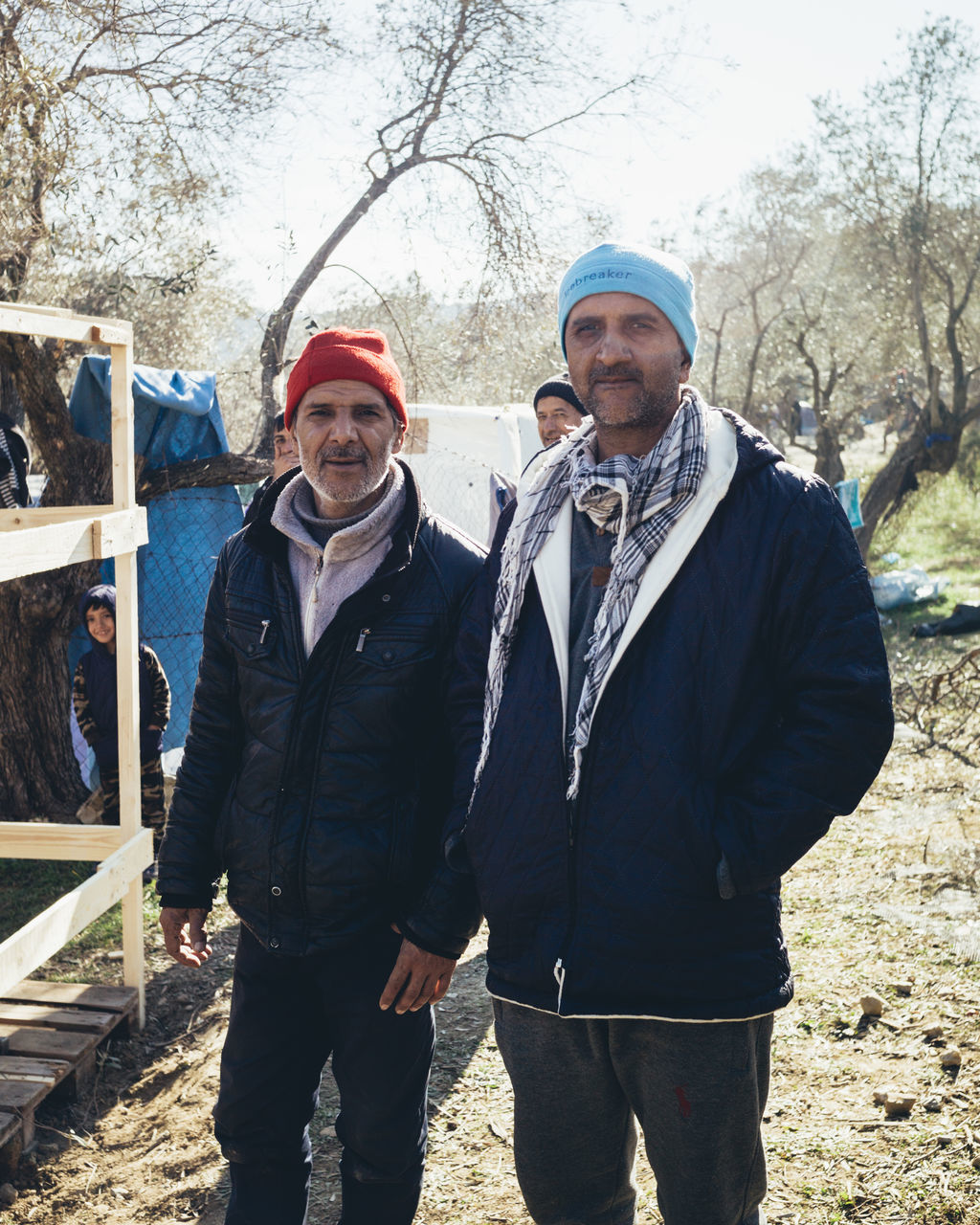 men, two people, adult, clothing, winter, looking at camera, nature, warm clothing, standing, togetherness, day, portrait, person, tree, front view, smiling, cold temperature, emotion, hat, lifestyles, leisure activity, outdoors, mature adult, happiness, knit hat, three quarter length, jacket, friendship, sky, occupation, young adult