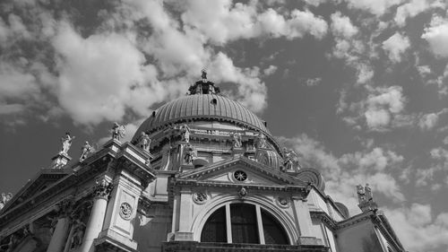 Low angle view of historical building against cloudy sky