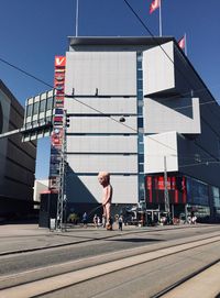 Man walking on street against buildings in city