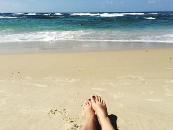 Low section of woman legs on beach
