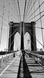 Rear view of suspension bridge in city