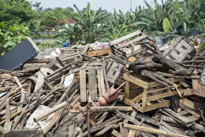 Stack of garbage on field by plants