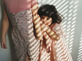 Midsection of woman with arms raised