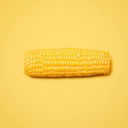 Close-up of corn against yellow background