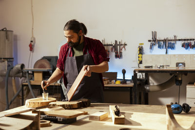 Side view of man working at table