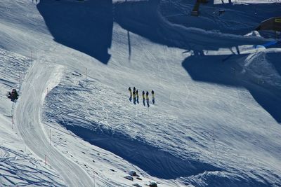 High angle view of people skiing on snow covered land