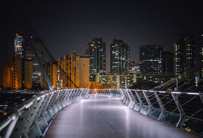 Illuminated modern buildings in city at night