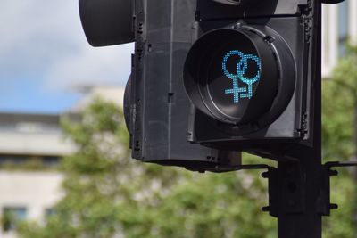 Close-up of road signal against trees