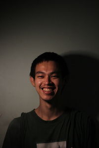 Low angle view of man standing against wall
