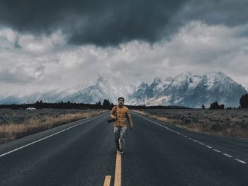 Rear view of man standing on road