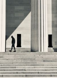 Full length of woman walking on staircase in building