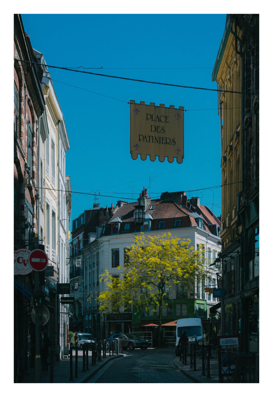 architecture, building exterior, built structure, city, sign, building, sky, communication, text, no people, nature, clear sky, transfer print, day, advertising, auto post production filter, outdoors, street, billboard, western script, road, residential district, blue, travel destinations