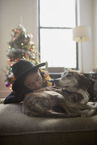 A young woman with a dog on a couch