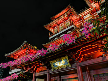 Low angle view of temple building against sky at night