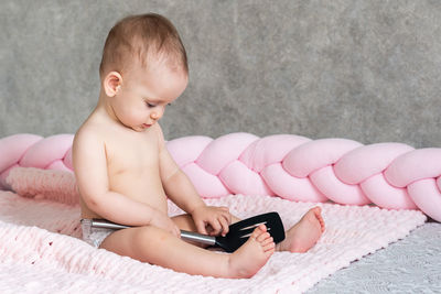 Portrait of cute baby boy with toy