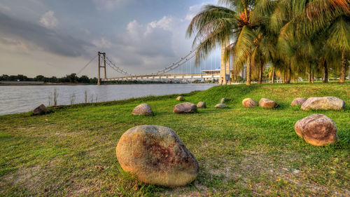 Bridge over river against sky during sunset