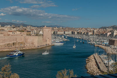 View of buildings in sea against cloudy sky