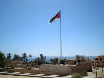 Flag against clear blue sky