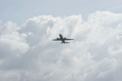 Low angle view of airplane flying in sky