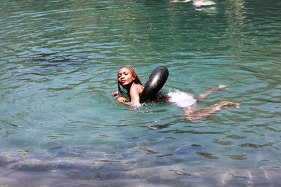 High angle view of woman swimming in lake