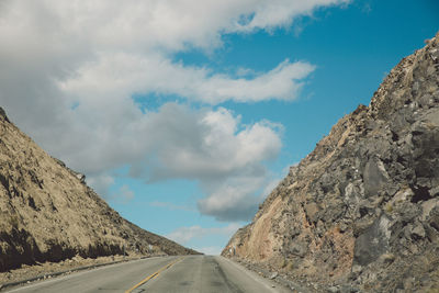 Road amidst mountains against sky